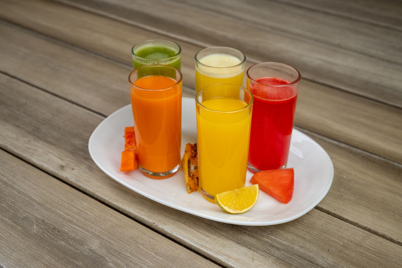 Glasses of fresh orange, pineapple and watermelon juice