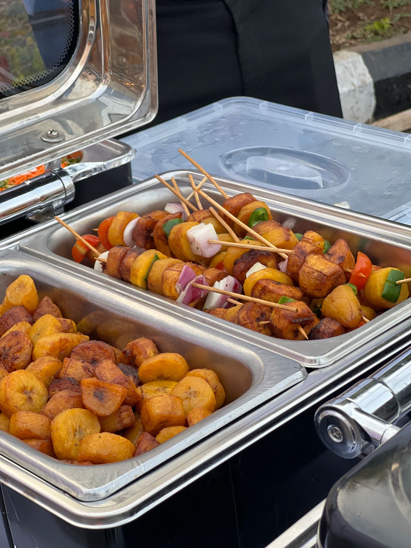Chafing dishes of dodo and chicken skewers